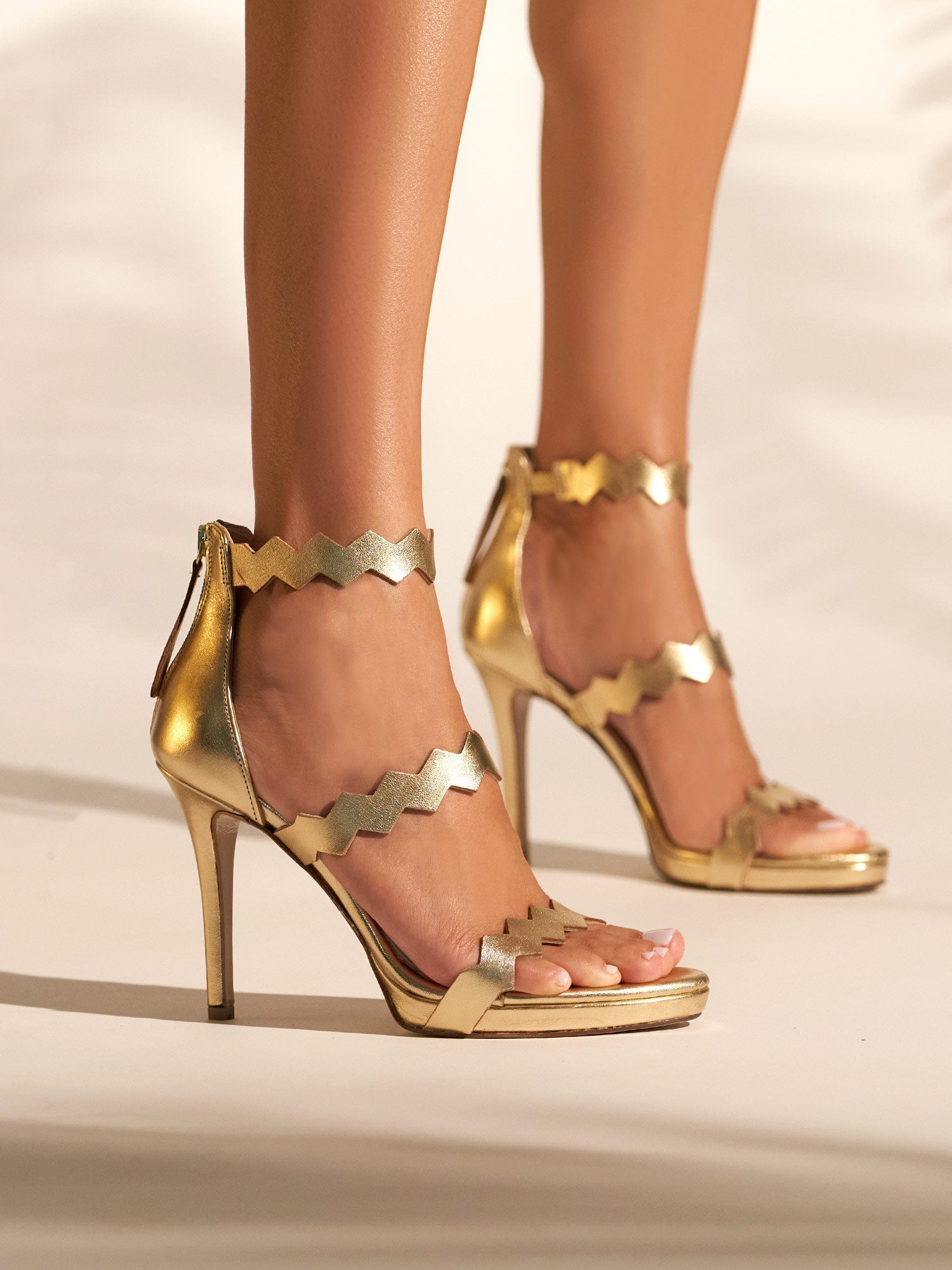Heeled leather sandals in gold