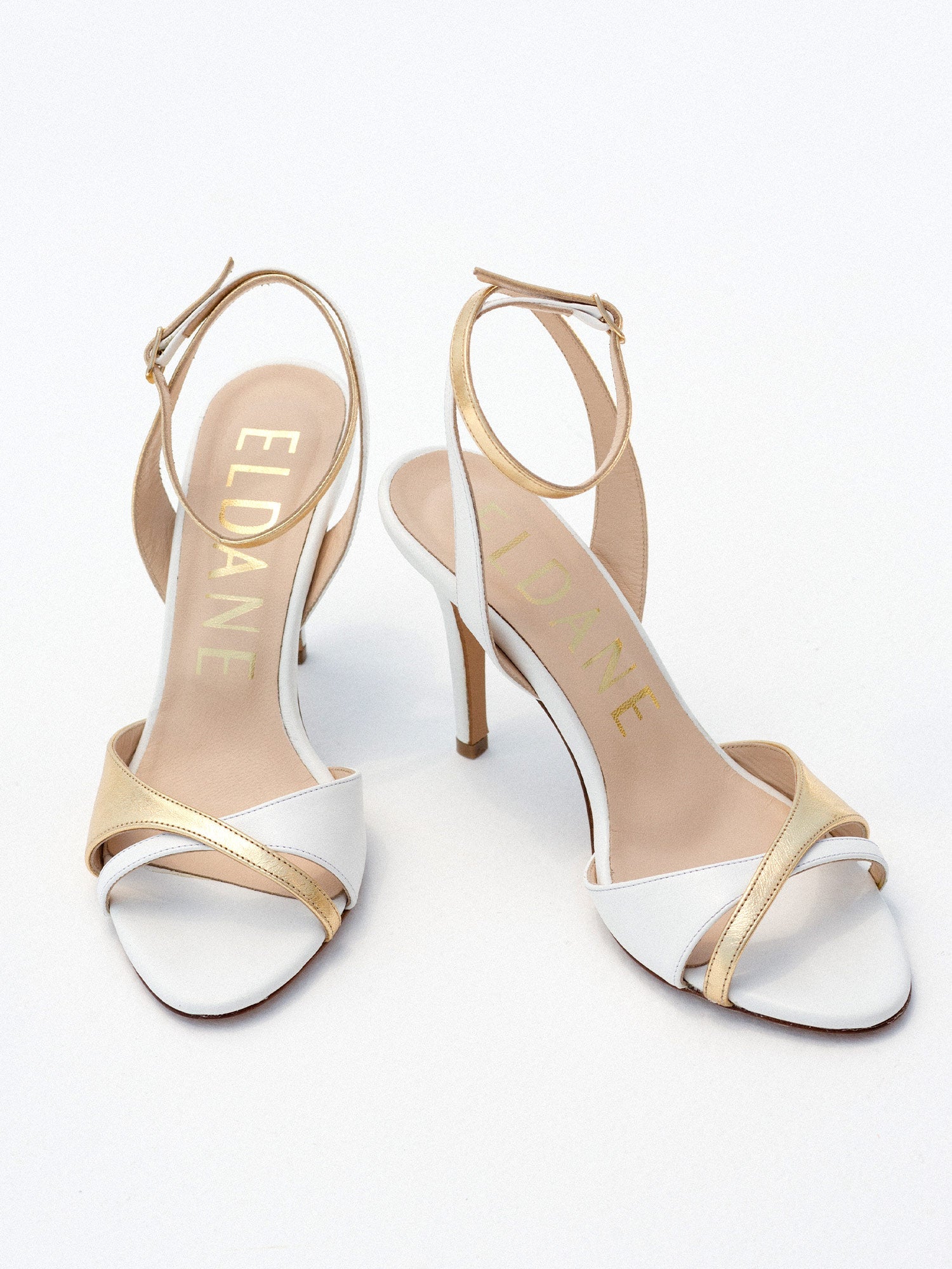 Heeled leather sandals in white and gold